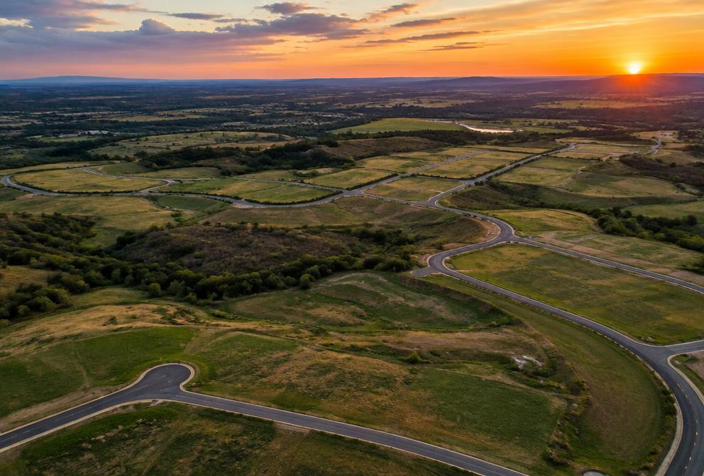 Aerial view of sprawling land parcels ready for development at sunset